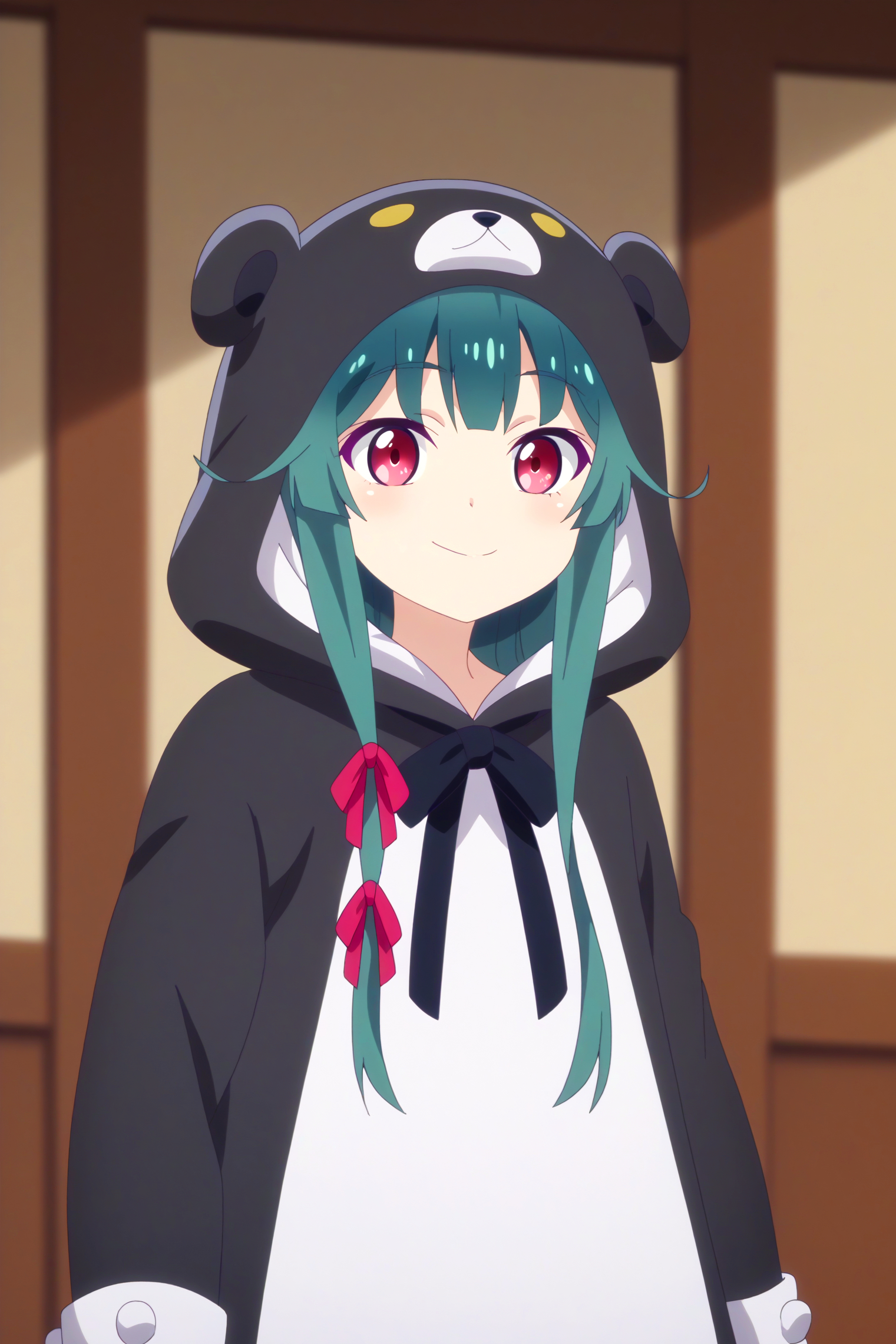 A smiling girl with red eyes and teal hair styled into two long forelocks, with the left one adorned with two red ribbons. She is wearing a black bear hoodie with a white front. The hoodie has a bear face on the hood, complete with black ears and a small white snout. The background is a room with a wooden paneling and a beige wall. 